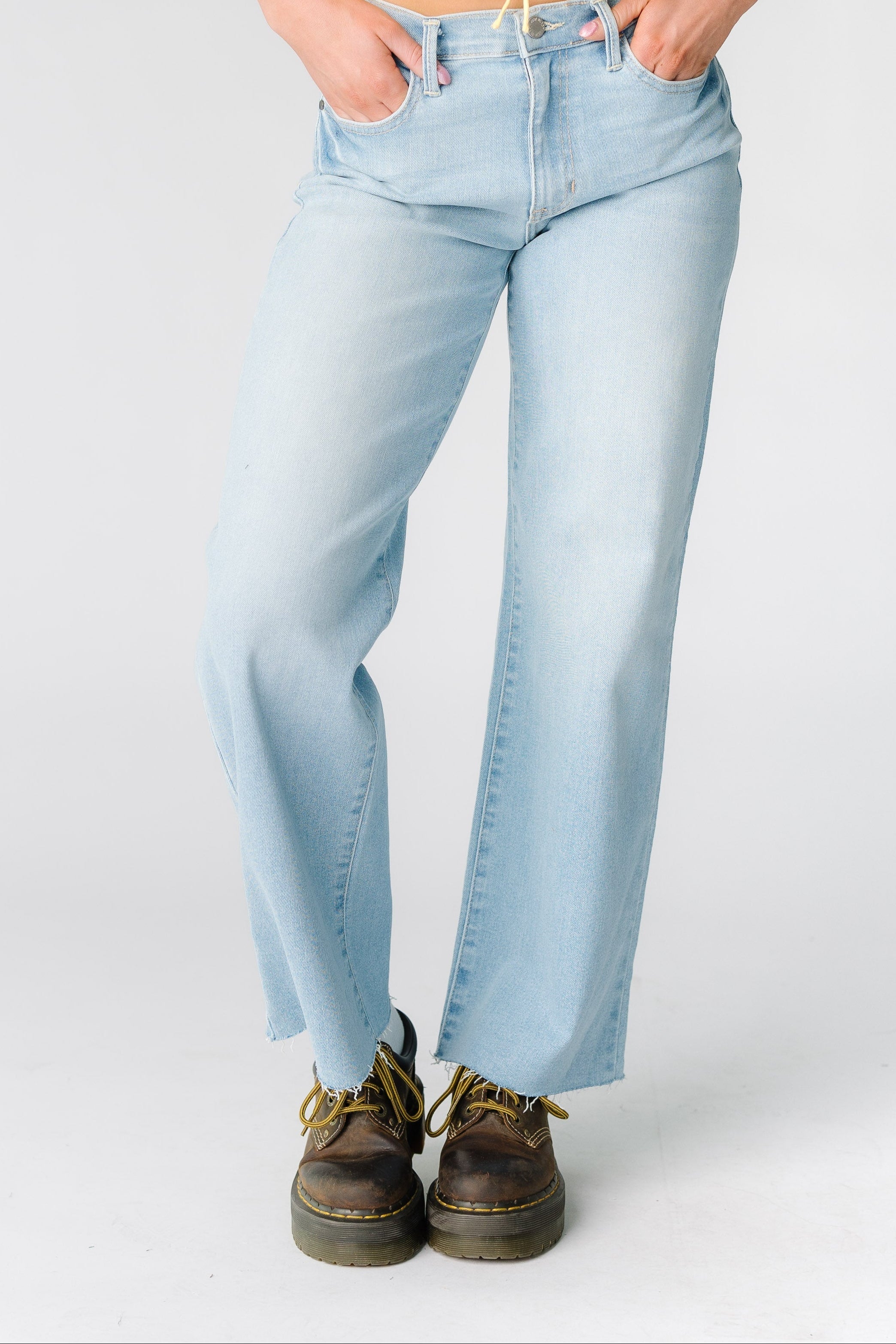 Awomanwearinglightdenimwidelegjeanswithscissorcuthems.jpg Slim Scissor Cut Denim