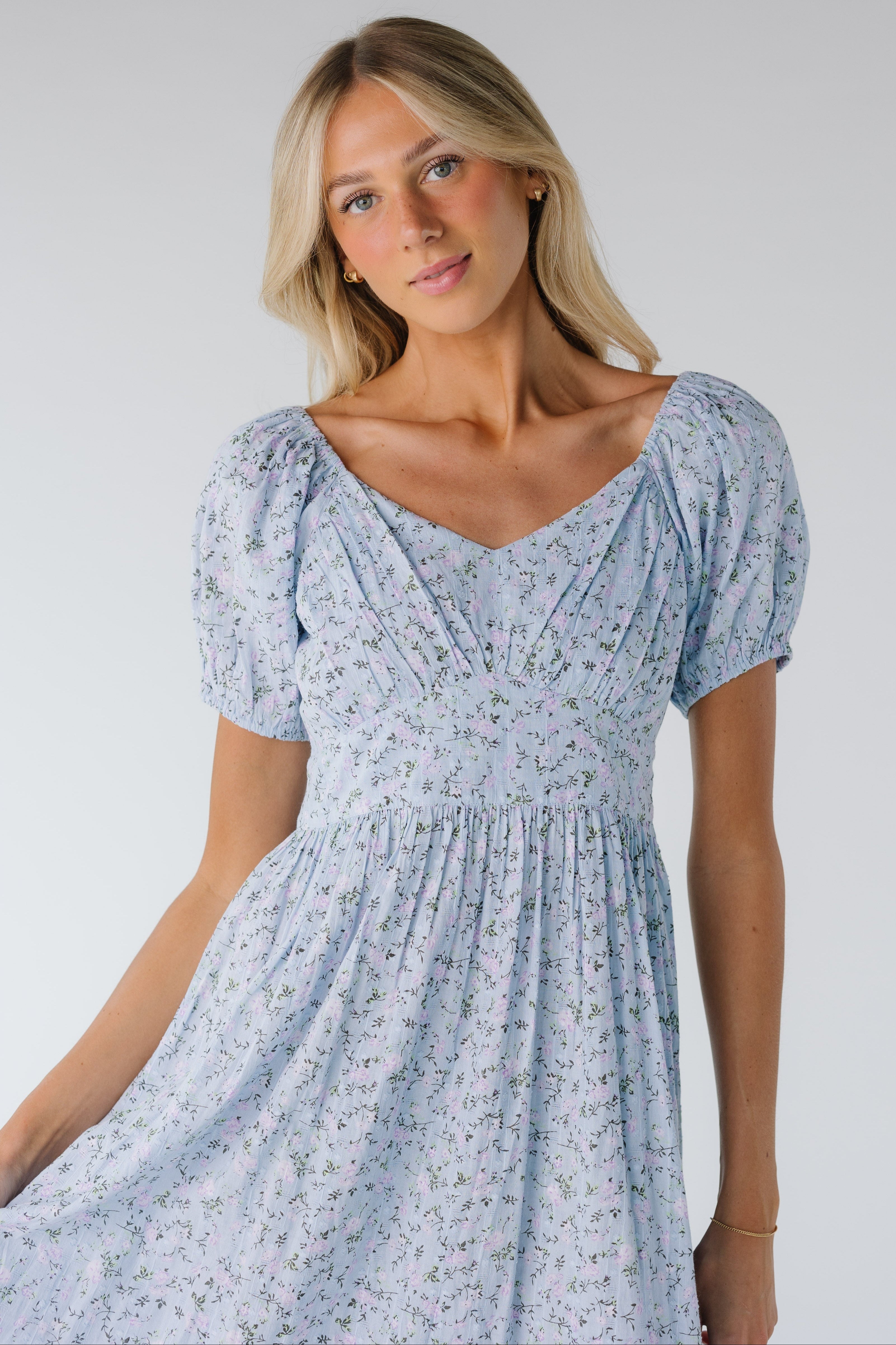 Close_view_of_light_blue_floral_midi_with_gathered_bodice_and_puff_sleeves.jpg Citrus Swiss Midi Dress