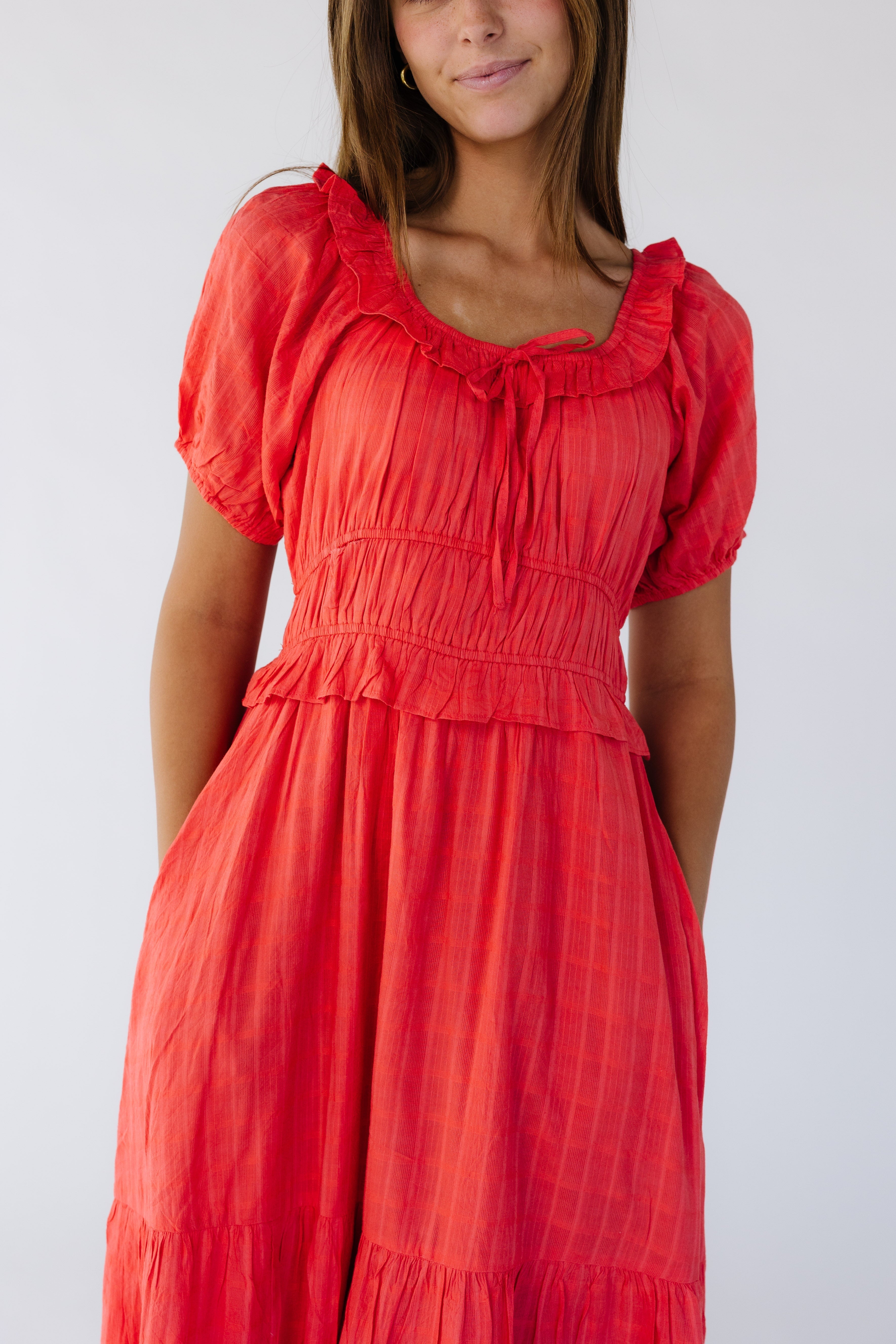 Closeupviewofayoungwomanwearingaredmididresswithshortpuffsleeves_widescoopneckline_widewaistbandandafullskirt.jpg Citrus Jena Dress - Red