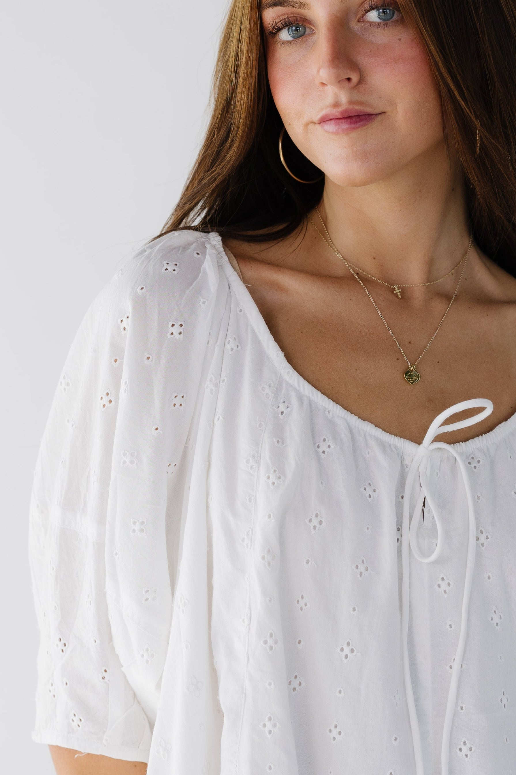 Closeviewofawomanwearingaloosefittingwhiteeyeletdresswithawidedrawstringneckline.jpg Citrus White Shifley Tunic