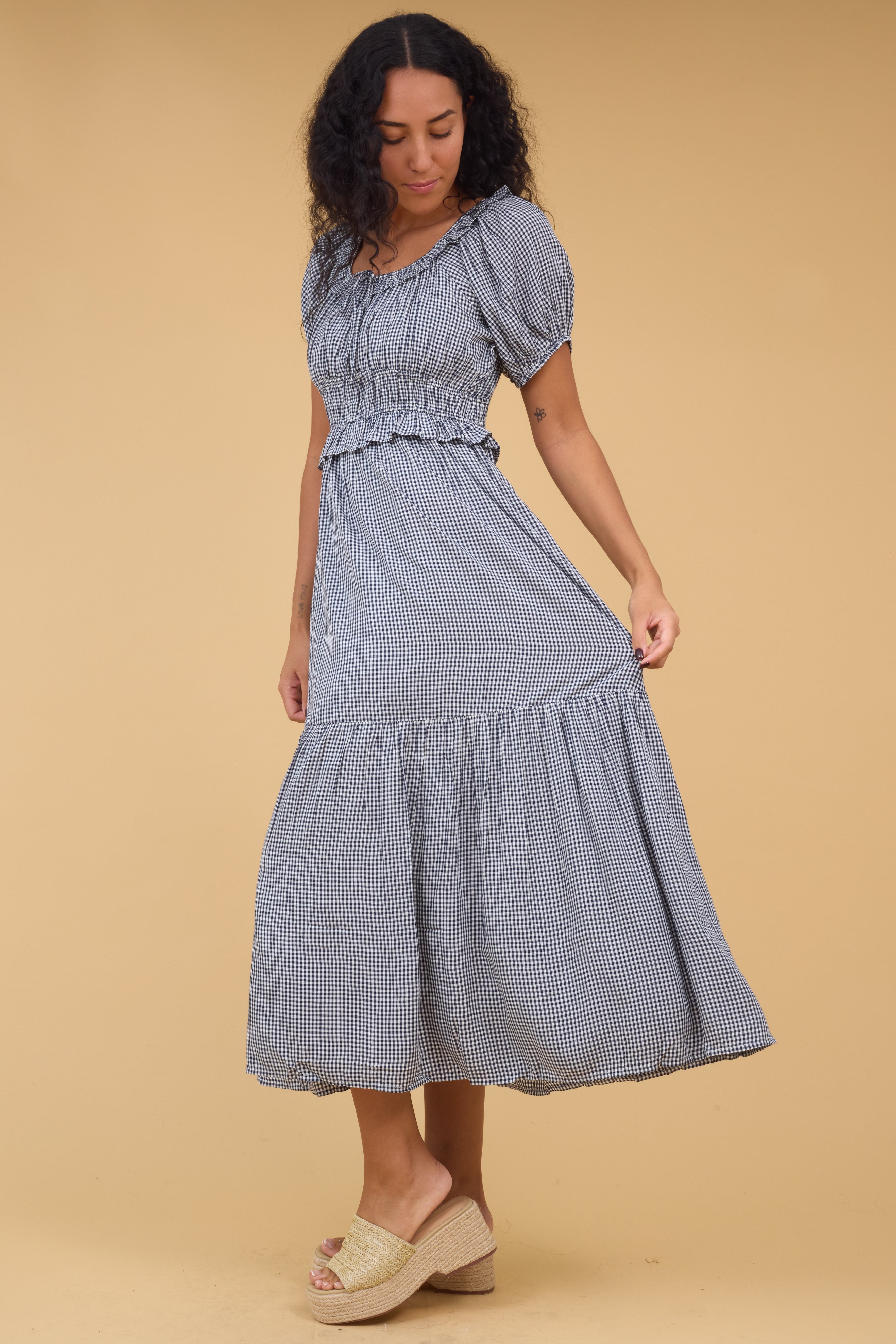 Sideviewofawomanwearinganavyginghammididresswithshortpuffsleevesandascoopneckline.jpg Citrus Jena Dress