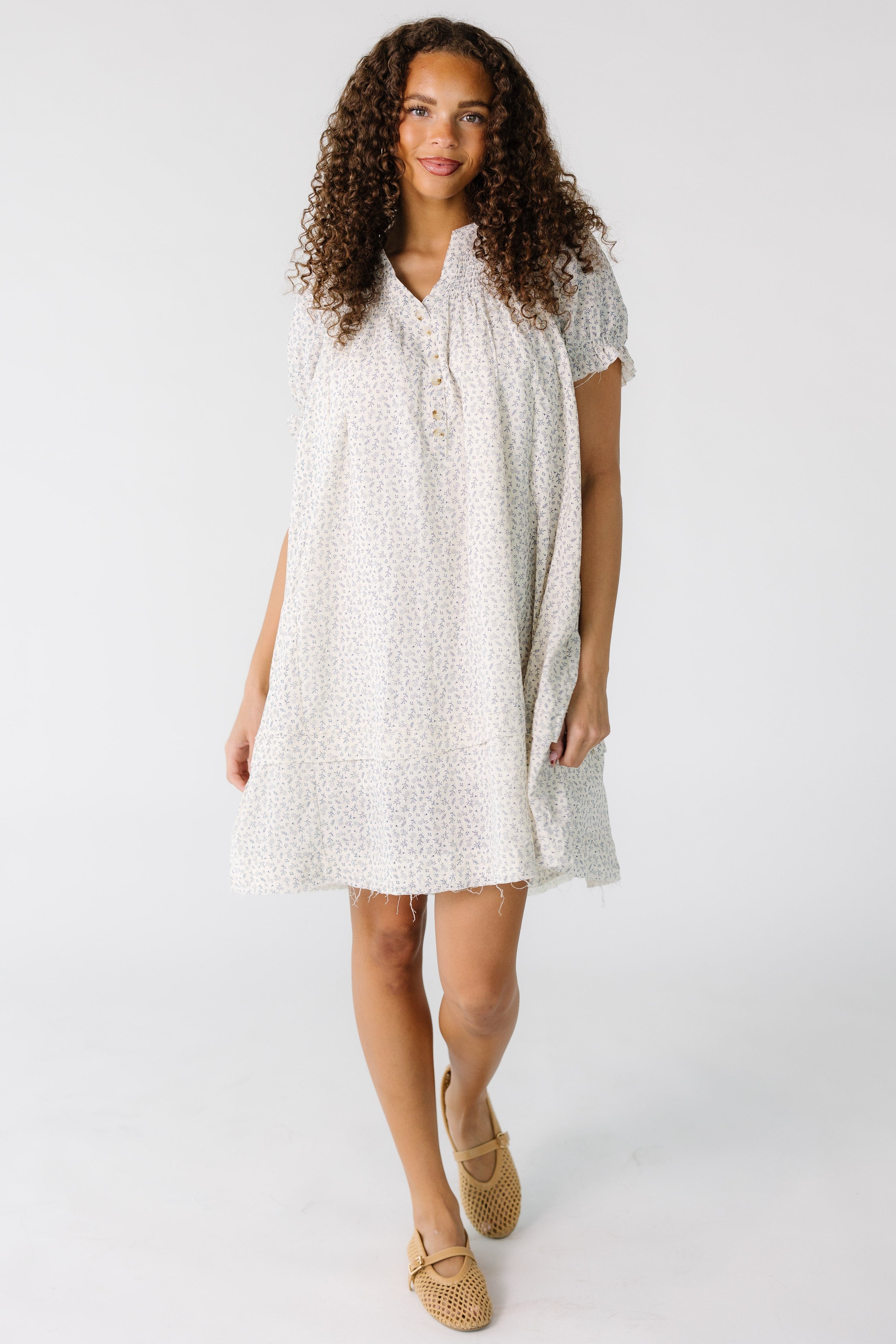 Teen_girl_wearing_a_grey_and_white_floral_knee_length_dress_with_a_short_button_placket_and_short_sleeves.jpg Brass & Roe Ditsy Collared Knee Dress
