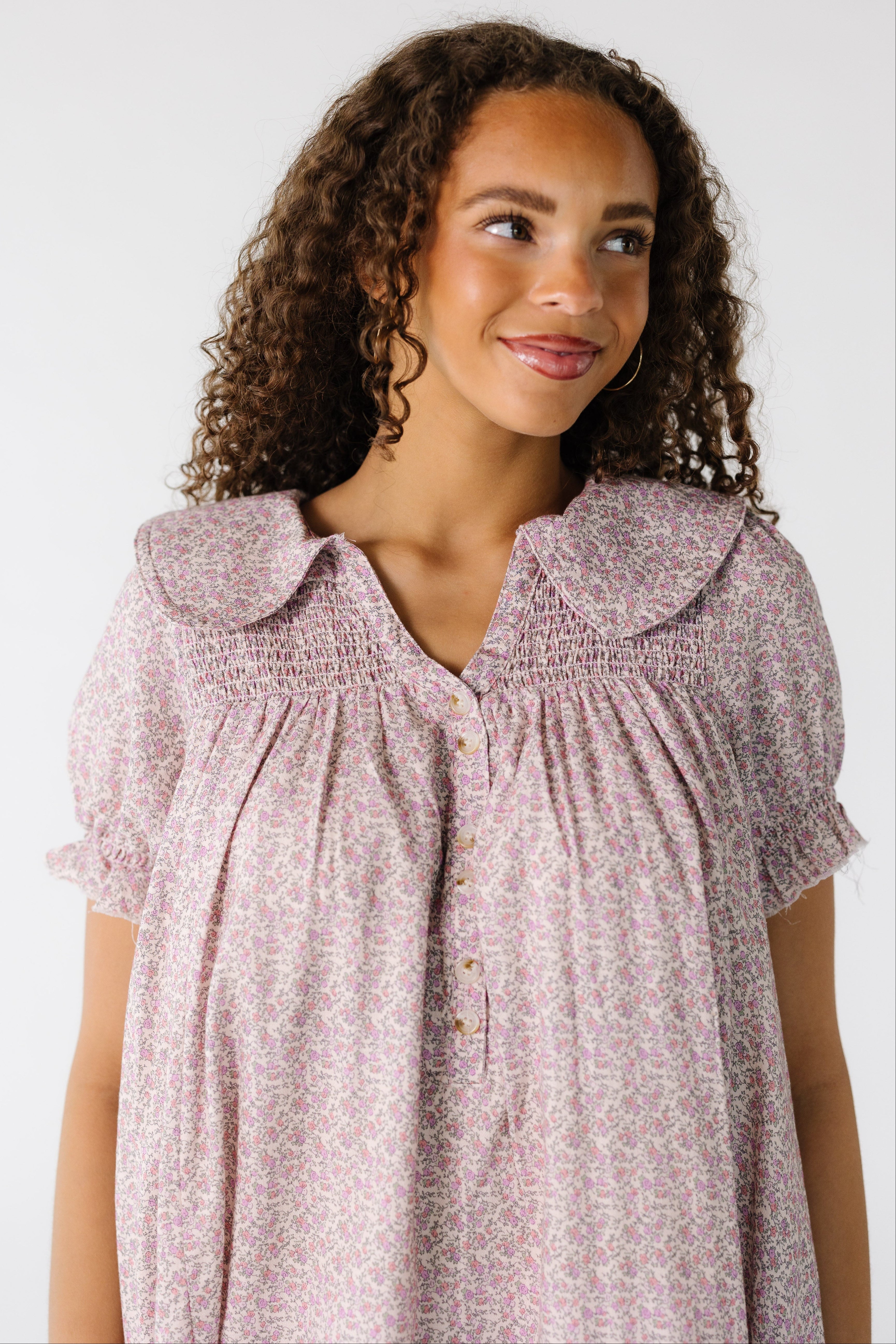 Teen_girl_wearing_a_modest_pink_floral_knee_length_dress_with_a_wide_collar_and_smocked_yoke.jpg Brass & Roe Ditsy Collared Knee Dress