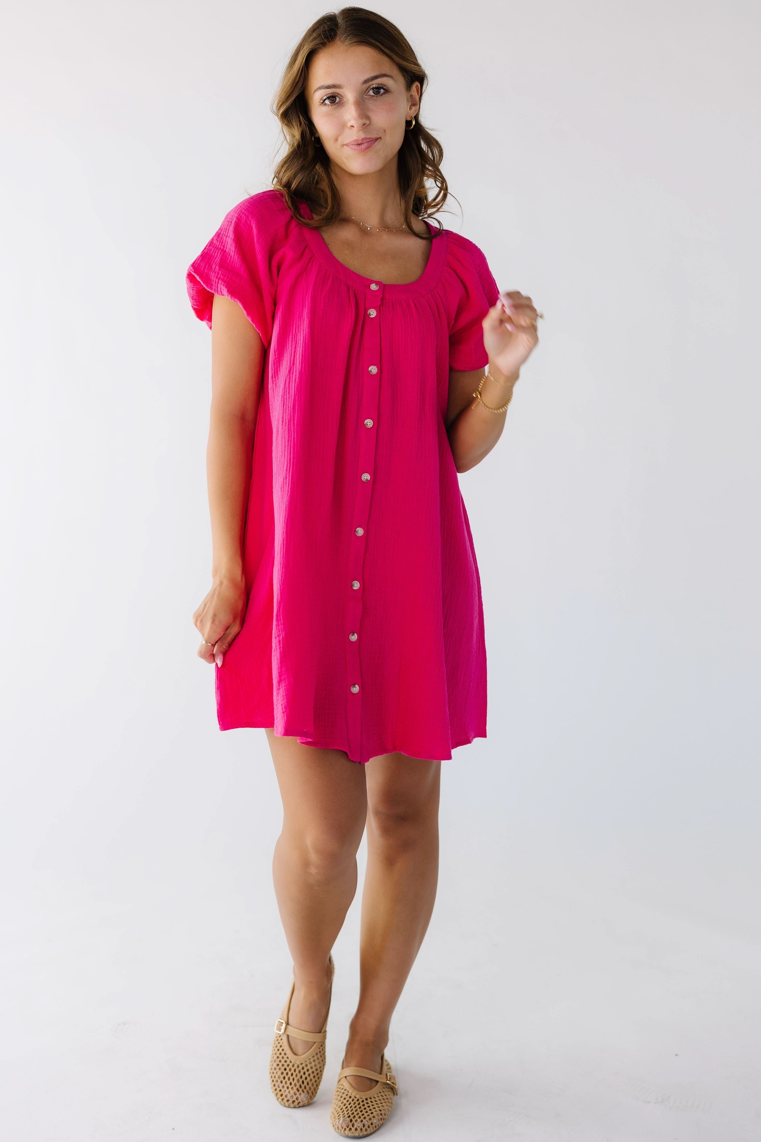 Woman_wearing_a_bright_pink_button_down_dress_hemmed_above_the_knee_with_short_puff_sleeves.jpg Brass & Roe Ellie Gauze Knee Dress
