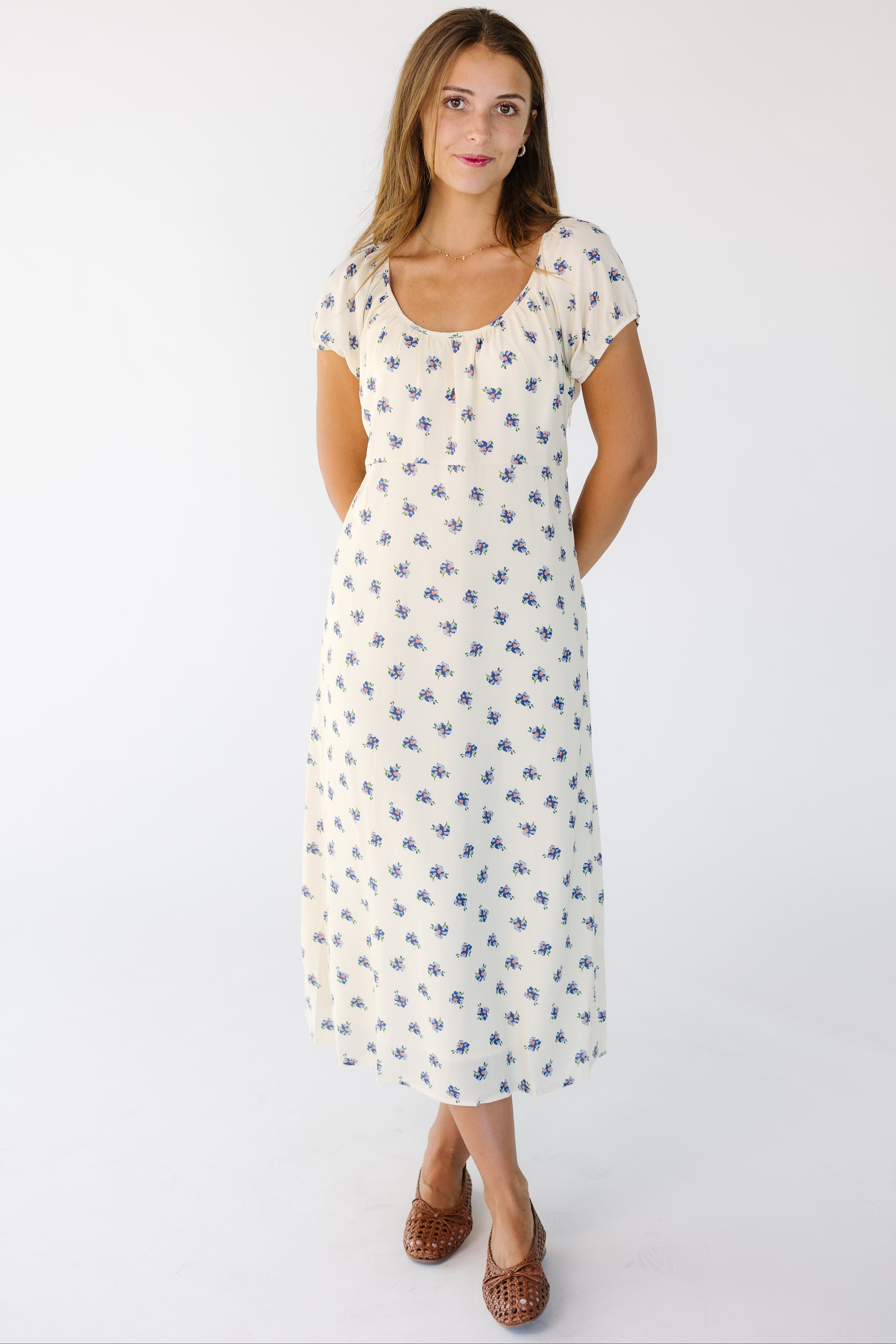 Woman_wearing_a_cream_and_blue_floral_print_midi_dress.jpg Brass & Roe The Bell Dress