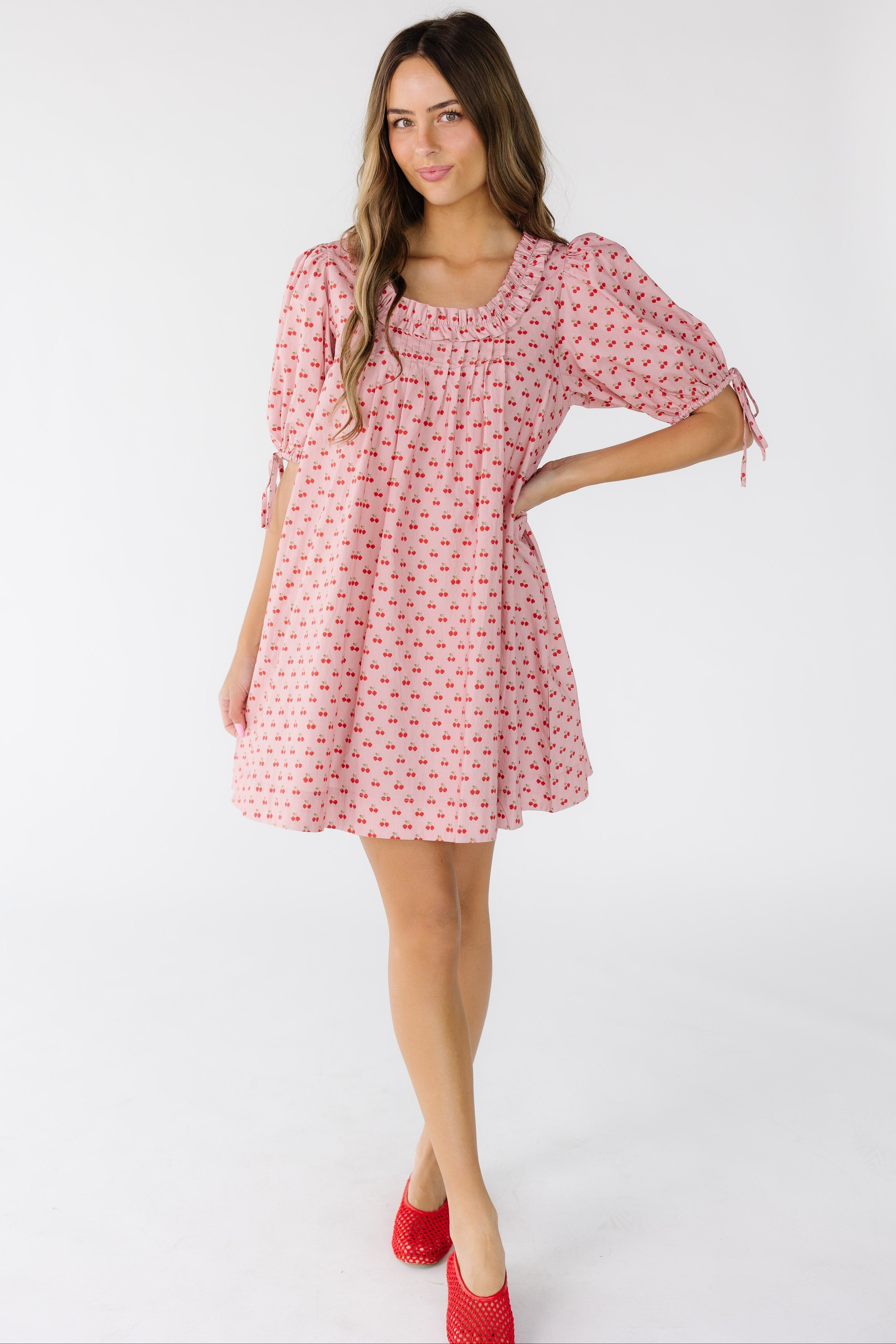 Woman_wearing_a_modest_mini_dress_with_a_scoop_double_ruffled_neckline_and_short_puff_sleeves.jpg Brass & Roe Nina Cherry Knee Dress