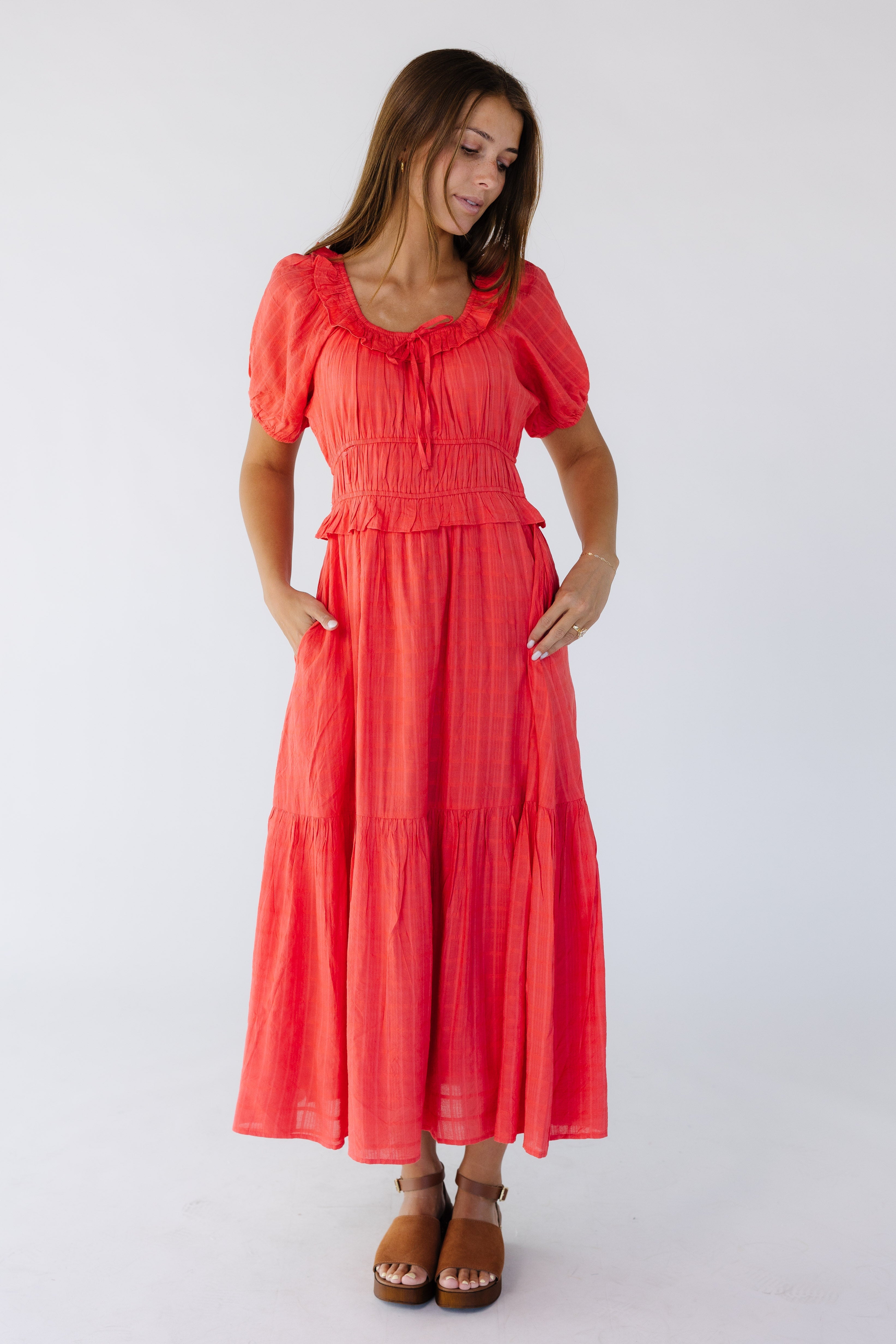 Womanwearingaredmididresswithawidescoopneckline_shortpuffsleeves_batheredbodice_wideclosefittingwaistbandandafulltieredandskirt.jpg Citrus Jena Dress - Red
