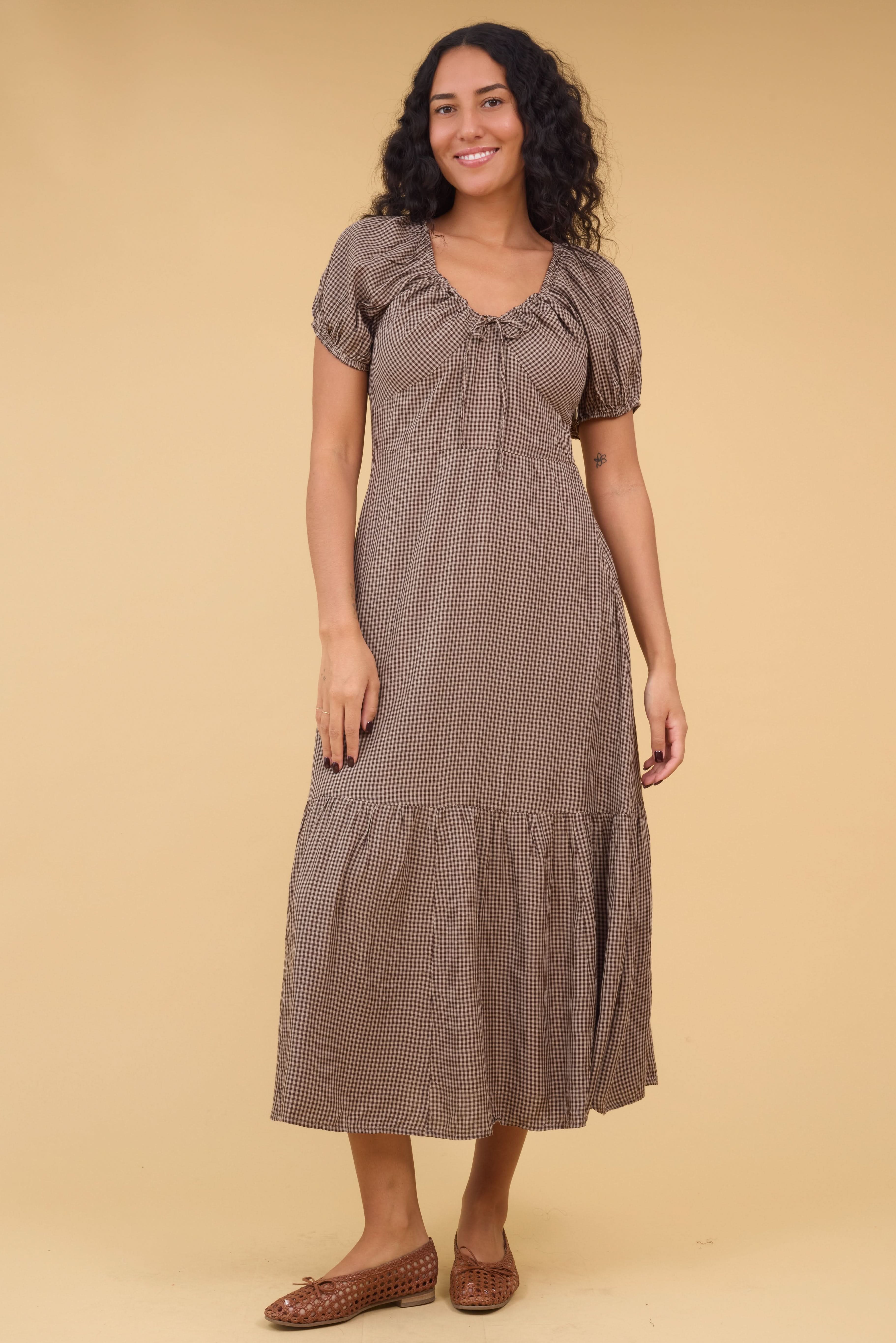 Young_woman_wearing_a_modest_brown_gingham_midi_dress_with_a_sweetheart_neckline_puff_sleeves_and_a_wide_bottom_ruffle.jpg Citrus Alba Dress