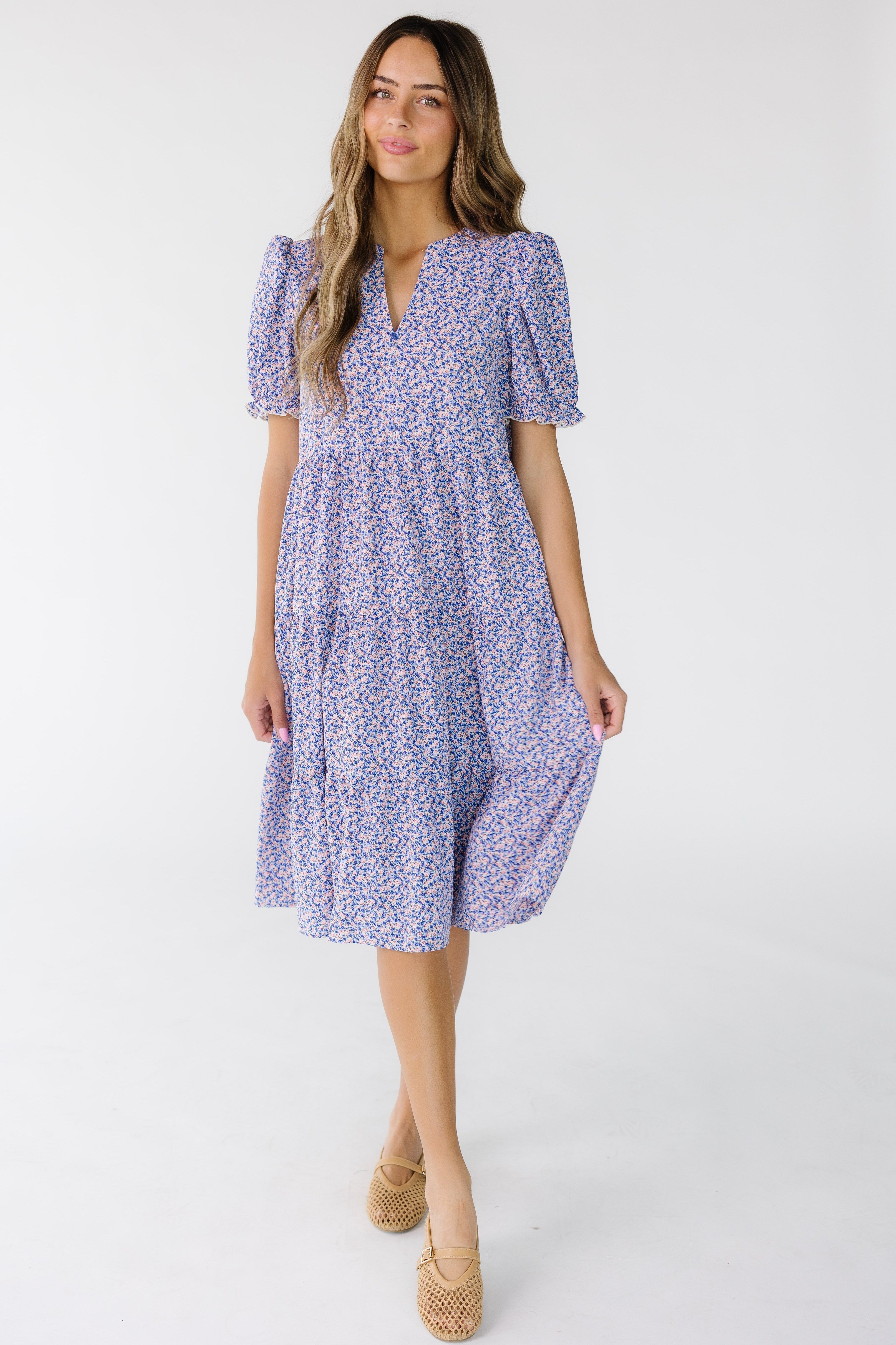 YoungwomanwearingakneelengthloosefittingtiereddresswithshortsleevesandaV-neckline.jpg Brass & Roe The Carol Dress