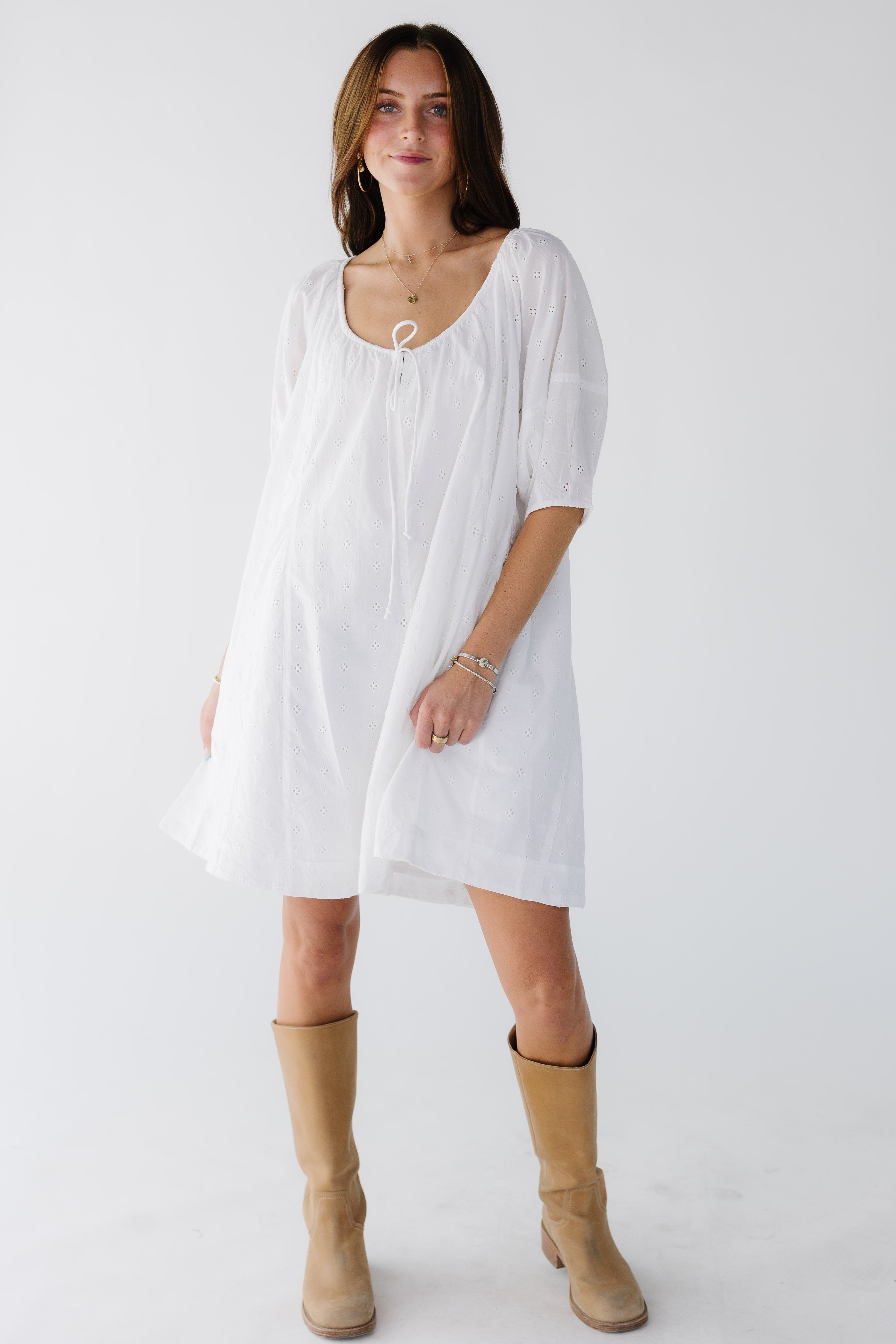 Youngwomanwearingashortwhiteeyeletloosefittingswingdresswithlargehalflengthballoonsleevesandawideneckline.jpg Citrus White Shifley Tunic